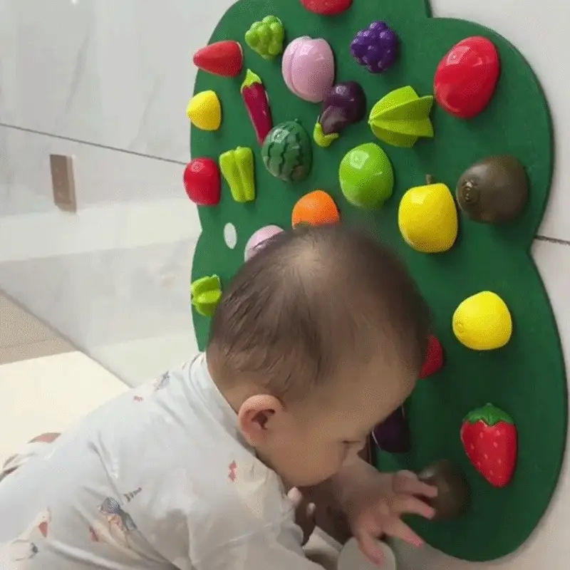 Child playing with the Felt Fruit Tree Activity Board
